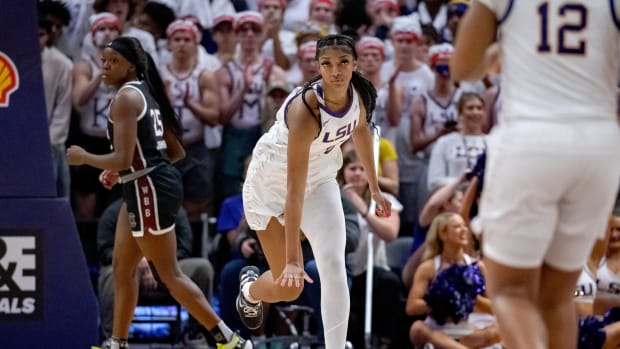 LSU Lady Tigers forward Angel Reese celebrates after a made shot.